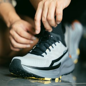 Athlete tying his shoes before a workout session.